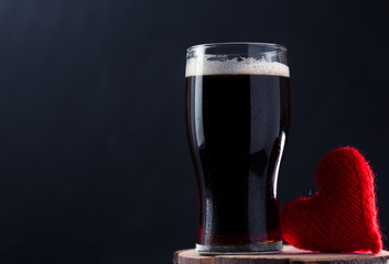 A glass of dark beer porter or stout, a surprise for a man on Valentine's day