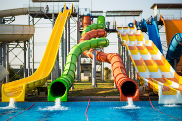 Colorful slides in outdoor water park in resort