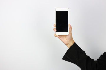 Business woman hand in black business suit uniform holding and showing mobile phone with black black screen on white background studio (advertisement concept)