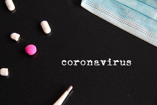 Novel Coronavirus 2019-nCoV outbreak concept. Coronavirus protective breathing mask with pills, and cornavirus title selective focus