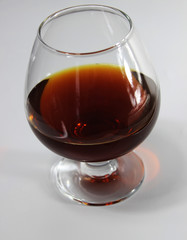 a glass of red wine on the table on a white background
