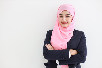 Beautiful muslim young asian woman wearing blue suit smiling confident in studio. Isolated white background portrait with beautiful face girl with pink hijab. Advertisement portrait concept.