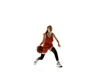 Young caucasian female basketball player in action, motion in run isolated on white background. Redhair sportive girl. Concept of sport, movement, energy and dynamic, healthy lifestyle. Training.