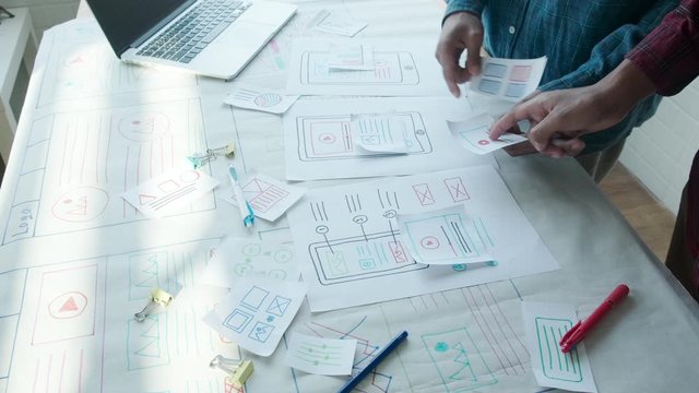 Web designer working laptop responsive design. Creative UI Ux designer teamwork meeting planning designing wireframe layout application development for smartphone screen mobile phone technology