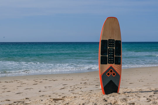 Surfboard standing in the sand on the beach