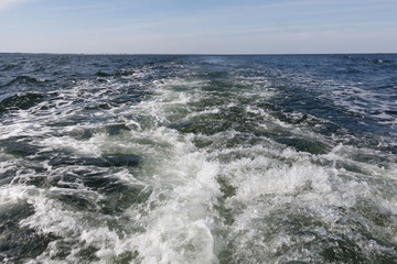 Water trail foaming behind a ferry boat in Baltic Sea
