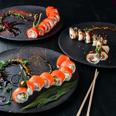 beautiful japanese sushi decorated on a black plate
