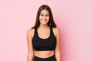 Young caucasian fitness woman doing sport isolated happy, smiling and cheerful.