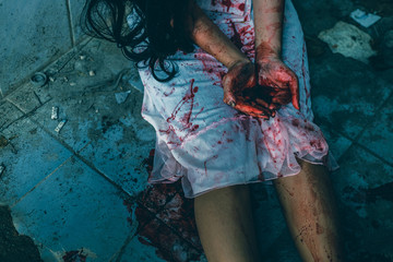 horror scence of women hands show red blood in her hands. Ghost women wear white dress stain blood at abandoned house