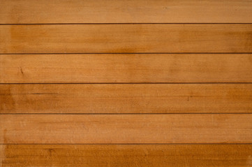 Nice and clean golden brown wood wall in horizontal line seamless pattern. Wooden grain texture and surface. Ideal for background or wallpaper with copy space. 