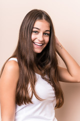 Young cute caucasian woman against a beige background © Asier