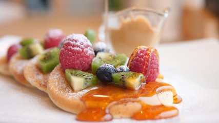 Pancakes With Berries, Fruits And Honey On Table, Closeup