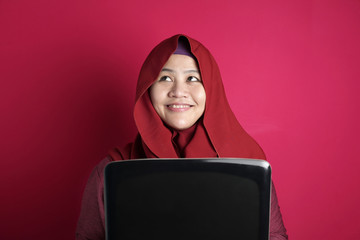 Muslim Businesswoman Working on Laptop at home, Thinking Gesture