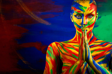 Color art face and body paint of woman for inspiration. Abstract portrait of the bright beautiful...