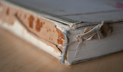 Close up on old destroyed by years book, ripped paper and ripped book