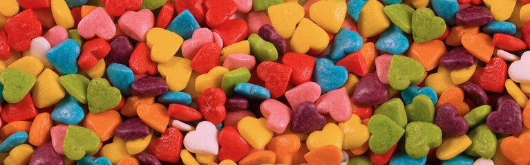 small multi-colored sweets scattered on the surface, shown close-up