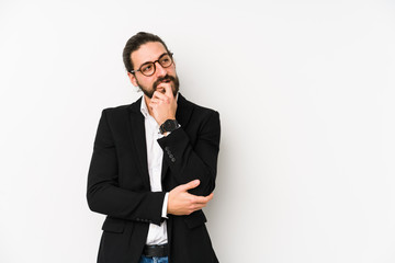 Young caucasian business man isolated on a white background relaxed thinking about something looking at a copy space.