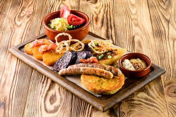 tray with fried egg, sausage and potato pancakes