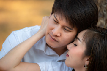 Portrait of young asian couple in love  in the forest,Thailand people happy to be together,Valentine day concept