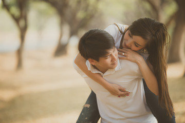 Portrait of young asian couple in love  in the forest,Thailand people happy to be together,Valentine day concept