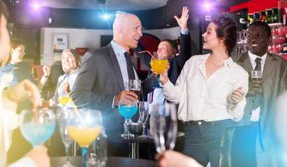Man talking to woman on corporate party