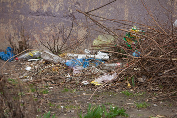 A close up of fence with a garbage or rubbish dump behind it .