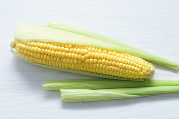  fresh organic corn in leaf, shelled and in pieces