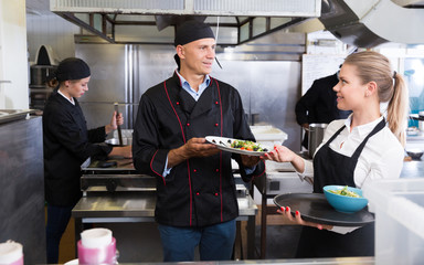 Chef checking dishes in kitchen