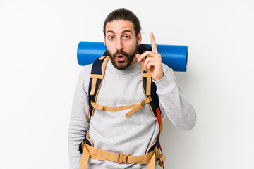 Young backpacker man isolated on a white background having an idea, inspiration concept.