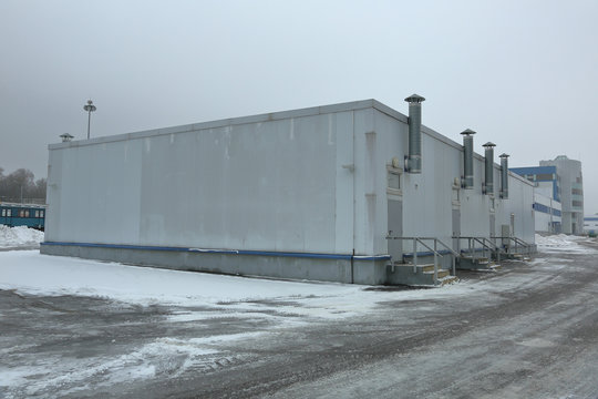 Gray industrial outbuilding of economic purpose on the factory site on a clouded day
