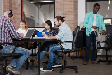 Young adults focused on work in office