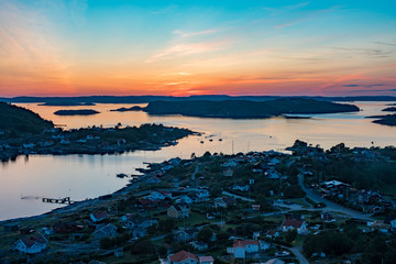 Setting sun over Archipelago of Sweden, Rörtången and big island Brattön - Low sun casts light over reflecting sea and valley.