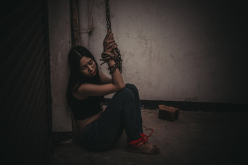Asian hostage woman Bound with rope at night scene,The thieves kidnapped for ransom,thailand people