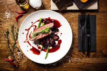 Tuinposter Duck breast served on a plate in restaurant © Maksim Toome