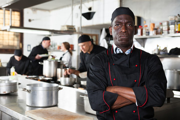 Aafrican american confident chef male in kitchen of restaurant