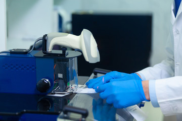 DNA laboratory. The expert puts the human DNA into the database using advanced laboratory technologies