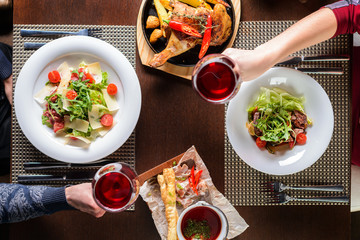 lovers man and woman drink wine in a restaurant