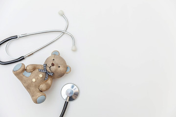 Simply minimal design toy bear and medicine equipment stethoscope isolated on white background....