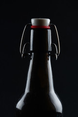 black bottle with a cap on a dark background
