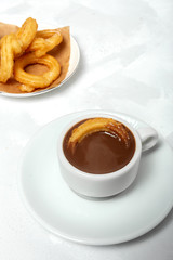 Cup of chocolate sauce with churros