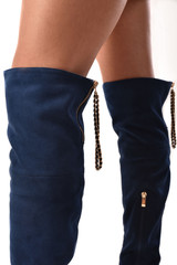 women legs in a high heels blue boots over the knee