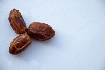Different useful dried fruits on a white background. Prunes, dried apricots, dates and raisins. Appetizing picture for fruit lovers. Yummy.