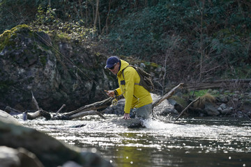 fly fisherman in river in winter