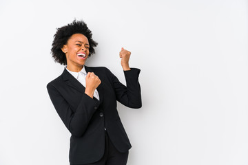 Middle aged african american business  woman against a white background isolated raising fist after...