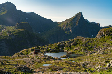 Northern Norway Landscape View of Beautiful mountain tops and reflecting lakes in Munkebu Huts Lofoten Islands at summer times. 