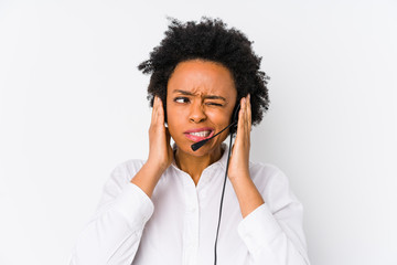 Young african american telemarketer woman isolated covering ears with hands.