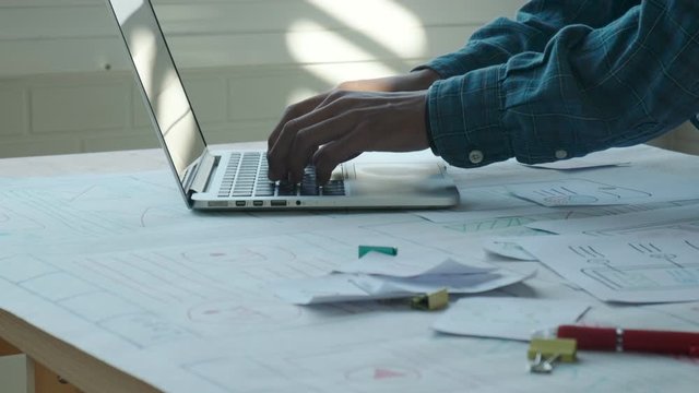 Web designer working laptop responsive design. Creative UI Ux designer teamwork meeting planning designing wireframe layout application development for smartphone screen mobile phone technology