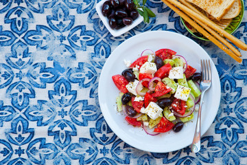 Greek salad. Fresh vegetables, feta cheese and black olives. Copy space. Top view.