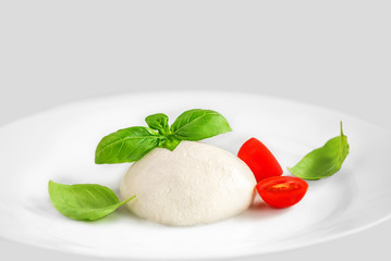 Mozzarella cheese Buffalo on a  plate over white background. Top view. Traditional Italian...