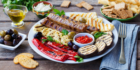 Kebab. Traditional meat kebab with grilled vegetables. Close up.